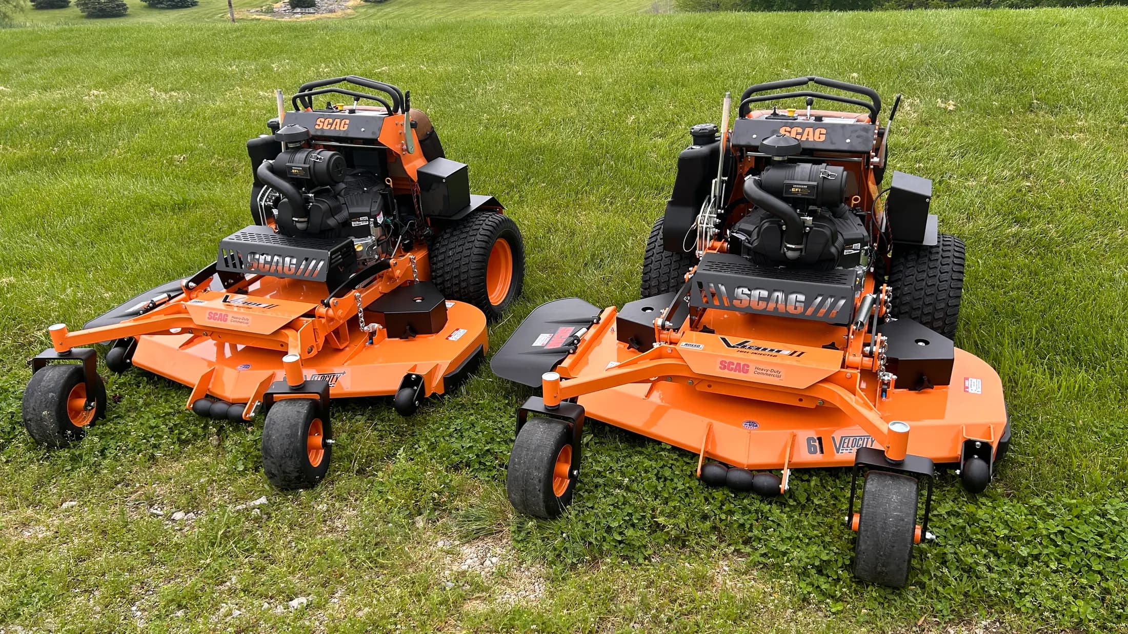Two commercial mowers ready for property maintenance